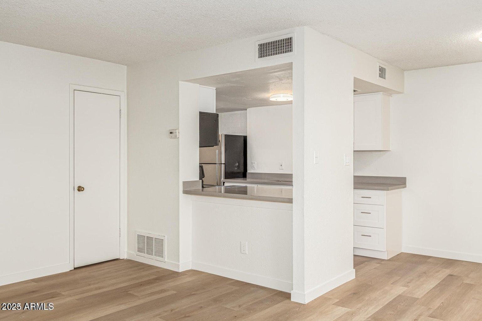 600 South Dobson Road, Unit 69 Mesa, AZ 85202 - Photo 12 of 24 a view of a kitchen with wooden floor