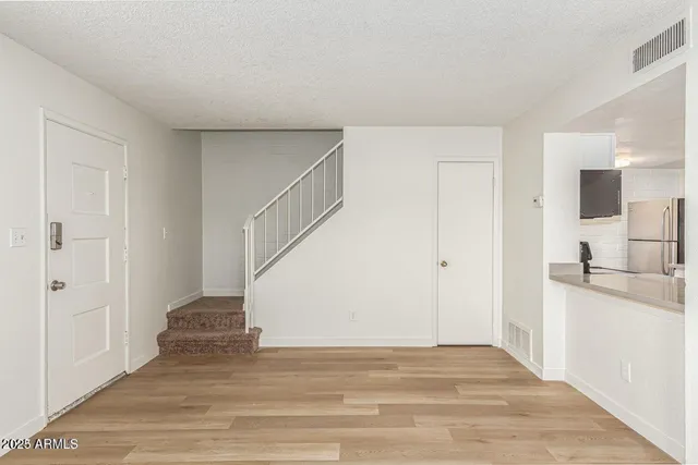 a view of a kitchen with a sink and a refrigerator