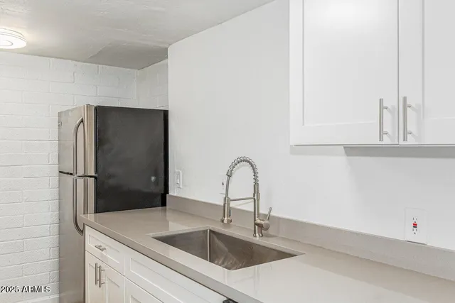 a close view of a sink and a refrigerator