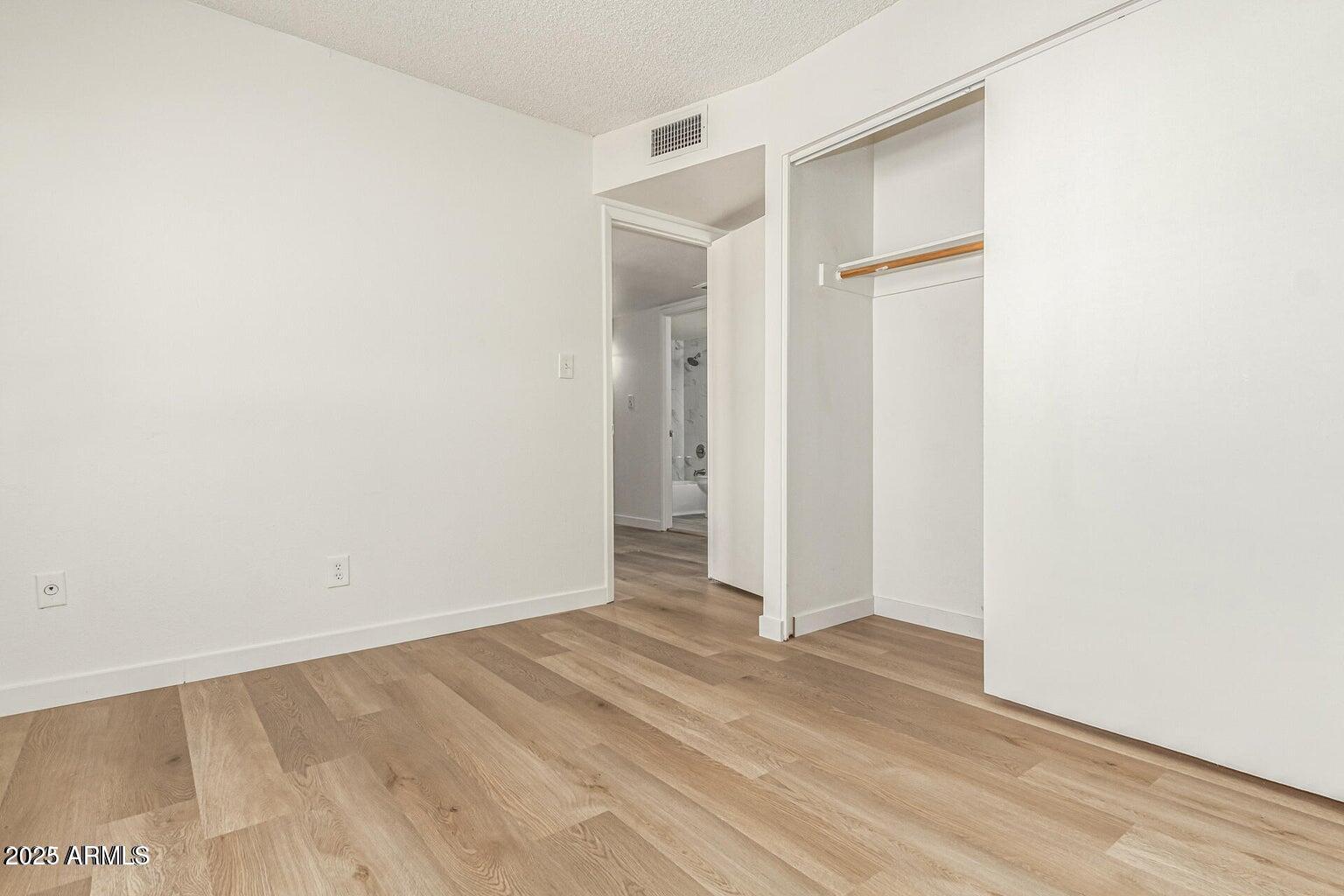 600 South Dobson Road, Unit 69 Mesa, AZ 85202 - Photo 4 of 24 a view of an empty room with closet and a window