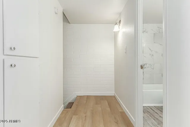 a view of a room with wooden floor