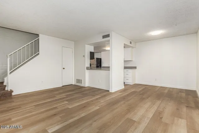 a view of a kitchen with a sink and a refrigerator