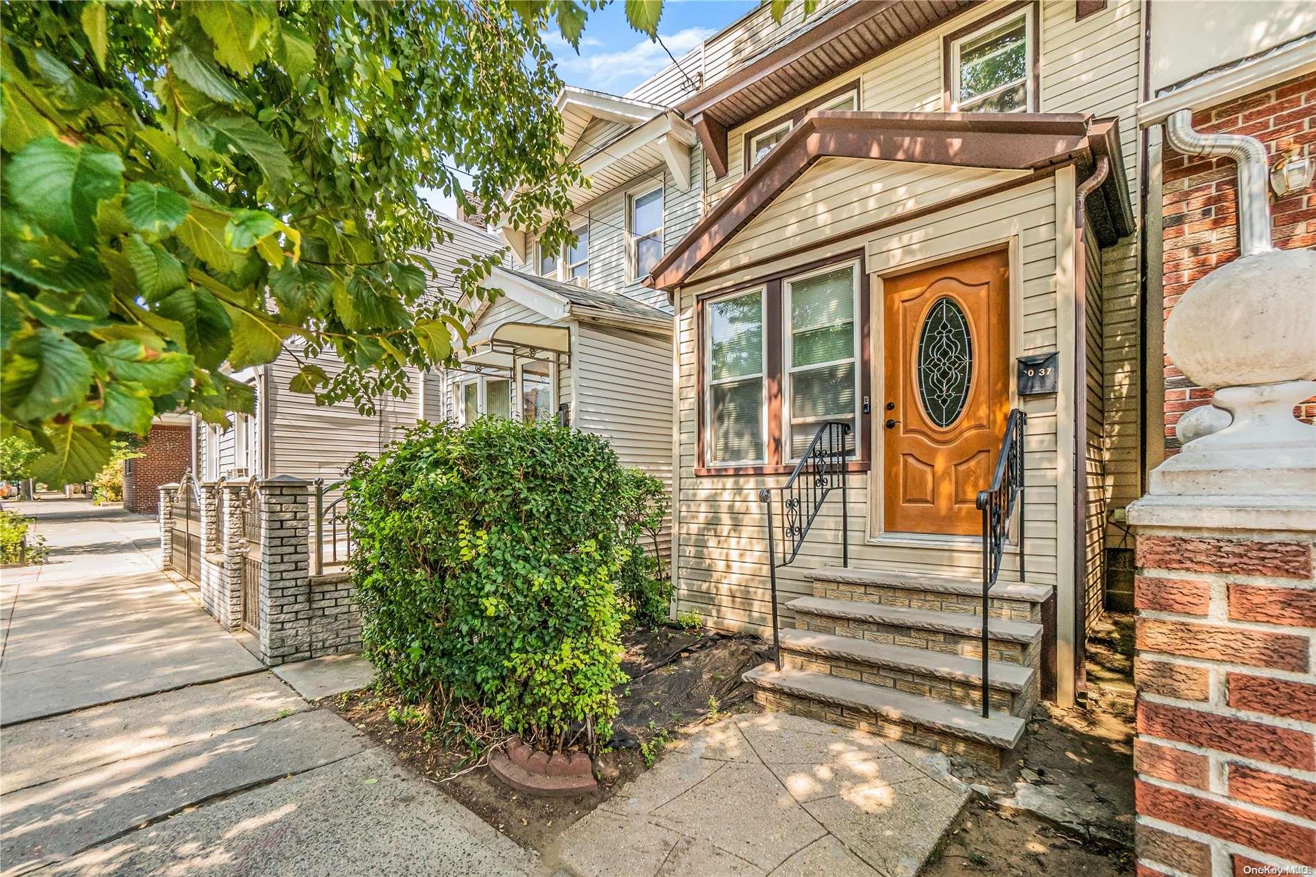 90-37 80th Street Queens, NY 11421 - Photo 1 of 1 a front view of a house with a garden