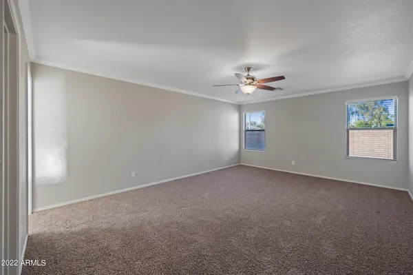 a view of a livingroom with a ceiling fan and window
