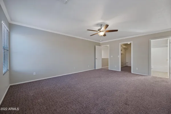 a view of a room with a ceiling fan and a window