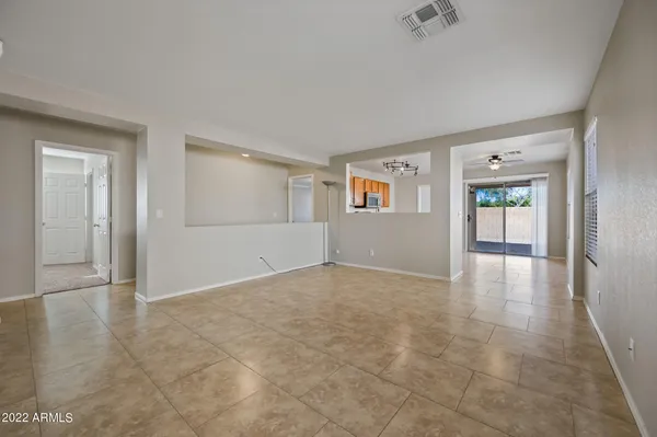 a view of an empty room with window and stairs
