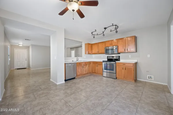 a view of kitchen with cabinets and window
