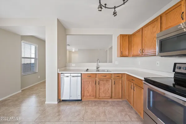 a kitchen with stainless steel appliances granite countertop a sink and dishwasher a stove top oven with wooden floor