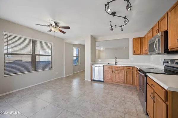 a large kitchen with a stove cabinets and stainless steel appliances