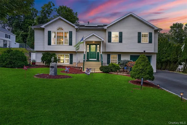 a front view of a house with a yard
