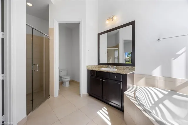 a spacious bathroom with a sink and a mirror