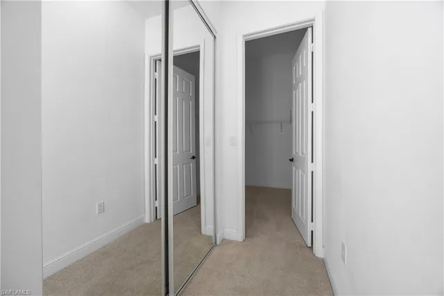 a view of an empty room with closet