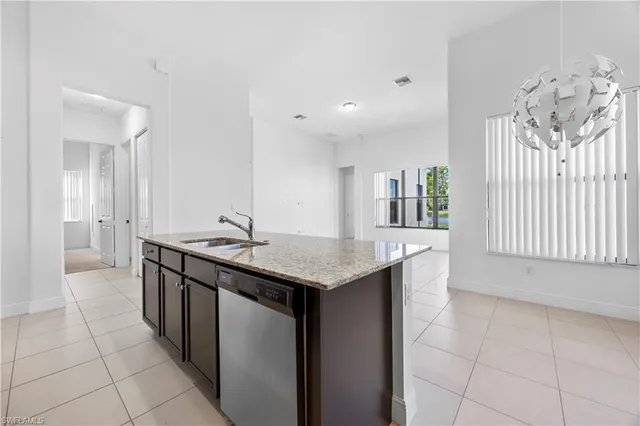 a kitchen with stainless steel appliances granite countertop a sink and a stove