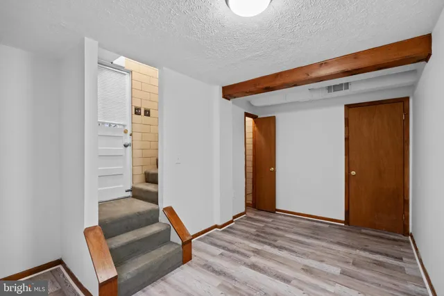 a view of an empty room and wooden floor