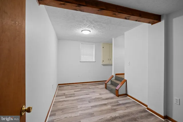 a room with wooden floor and white walls