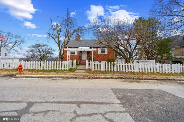 a view of a house with a yard and a garden