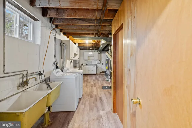 a hallway with a sink and wooden floor