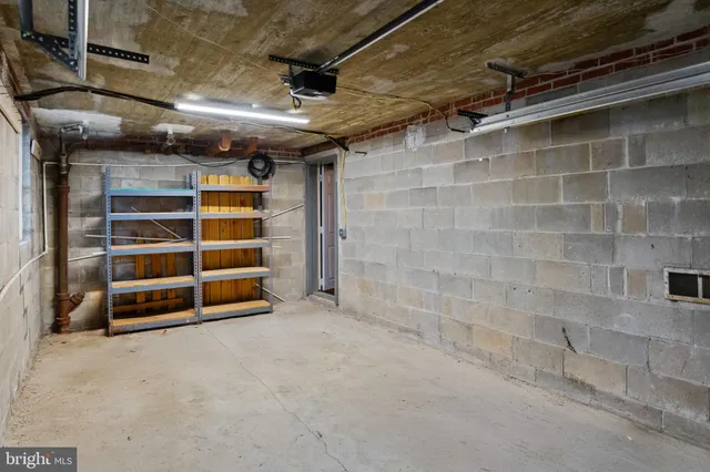 a view of an empty room with a brick wall