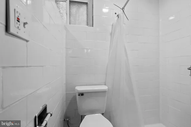 a bathroom with a shower and toilet