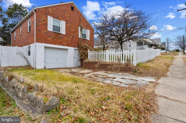 a front view of a house with a yard covered with snow