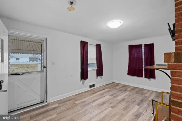a bedroom with a bed and a large mirror on the dresser