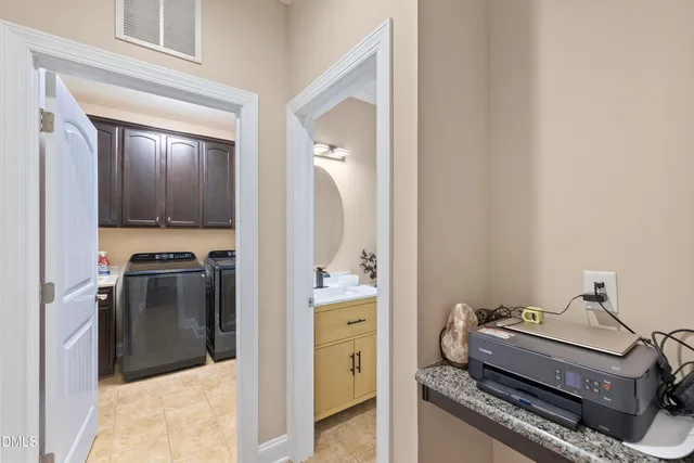 a living room with stainless steel appliances furniture and a flat screen tv