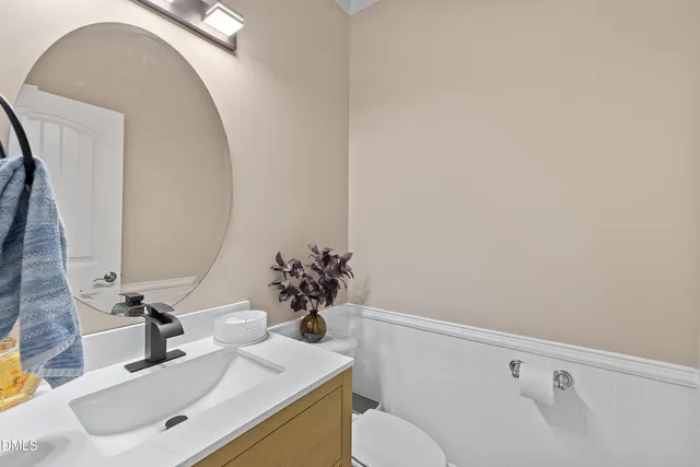 a kitchen with stainless steel appliances refrigerator dining table and chairs