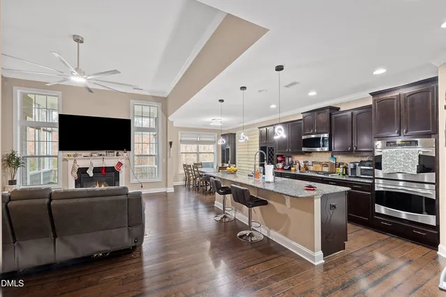 a kitchen with stainless steel appliances granite countertop a sink a stove and refrigerator