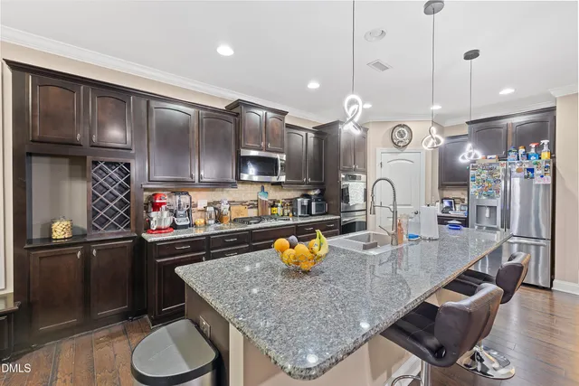 a living room with granite countertop furniture and a flat screen tv
