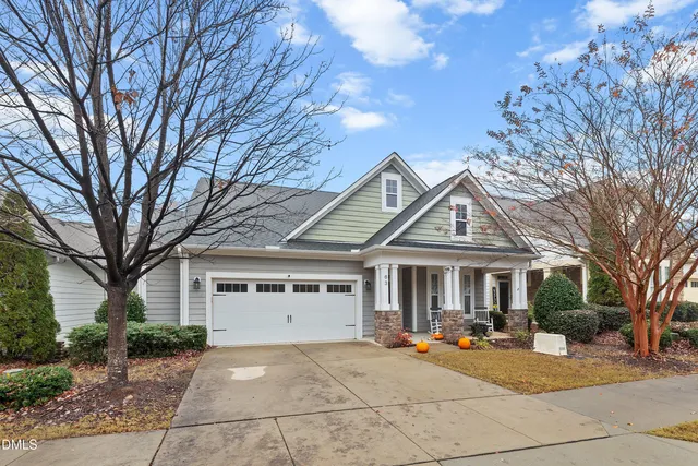 a view of a house with sitting area and large tree
