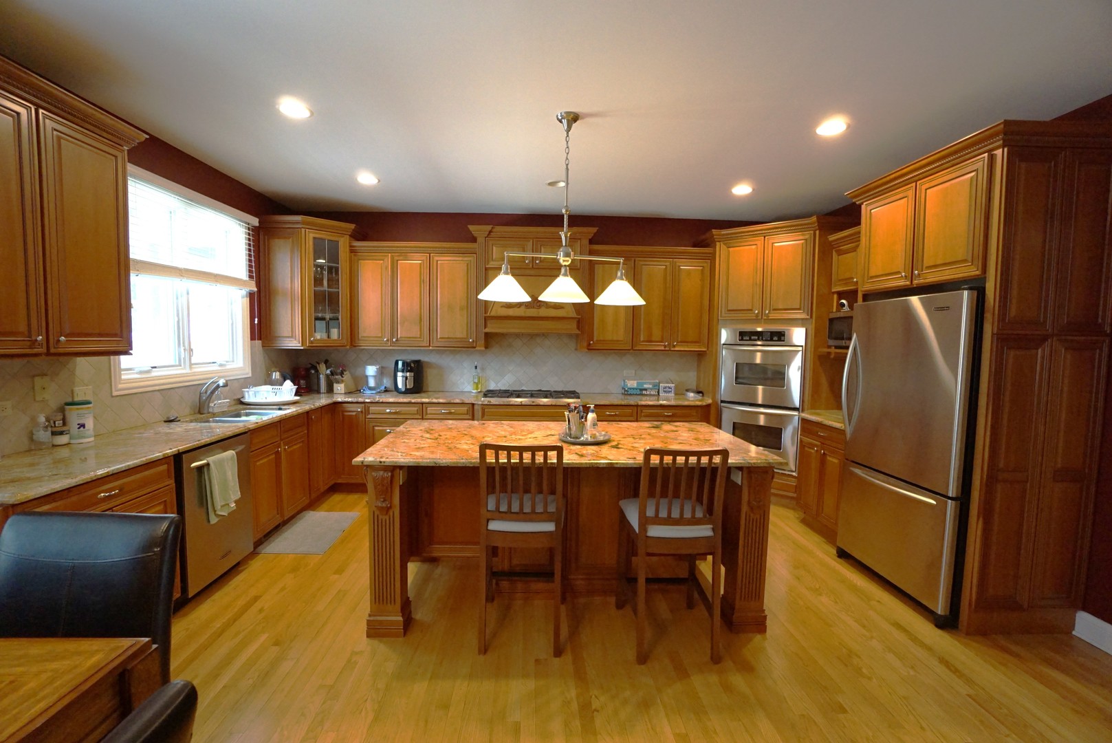 8 North Smith Street Palatine, IL 60067 - Photo 6 of 46 a kitchen with stainless steel appliances granite countertop a refrigerator a sink dishwasher a dining table and chairs with wooden floor