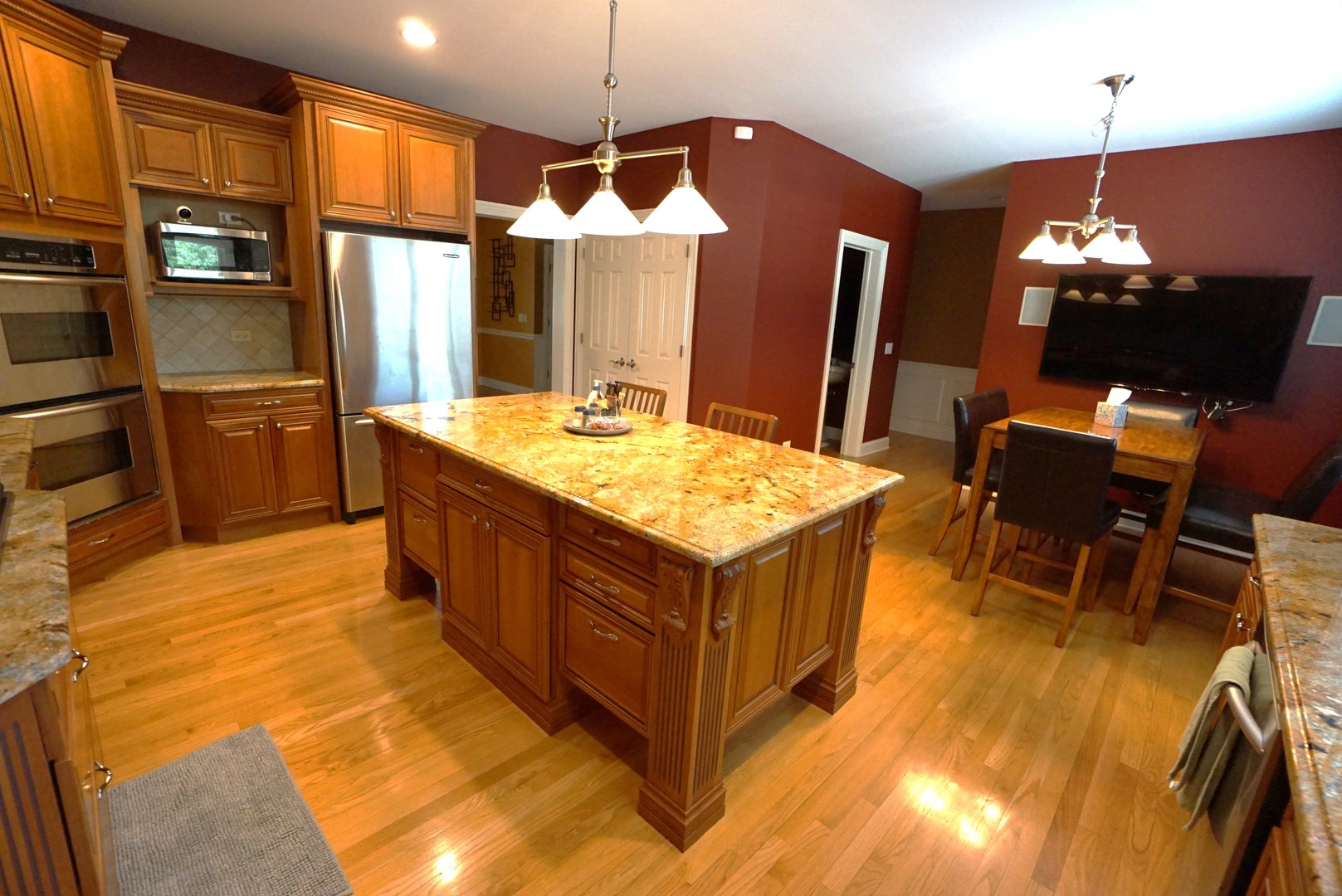 8 North Smith Street Palatine, IL 60067 - Photo 7 of 46 a kitchen with stainless steel appliances kitchen island granite countertop a table chairs and a refrigerator