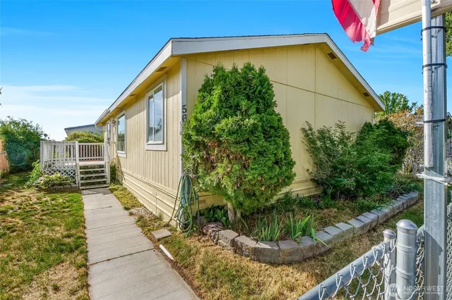 a view of a house with a flower garden