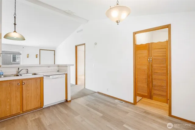 a kitchen with a sink a stove a refrigerator and a window