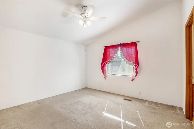 a view of a hallway with a chandelier fan