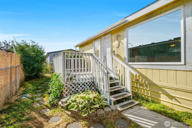 a view of balcony with wooden floor and fence