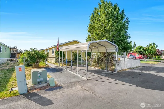 a patio with a table and chairs under an umbrella