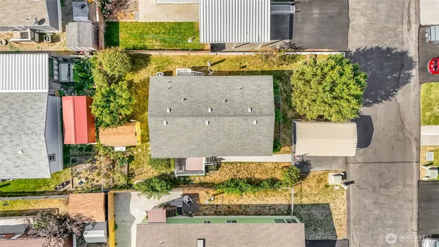 an aerial view of a city with lots of residential buildings ocean and mountain view in back