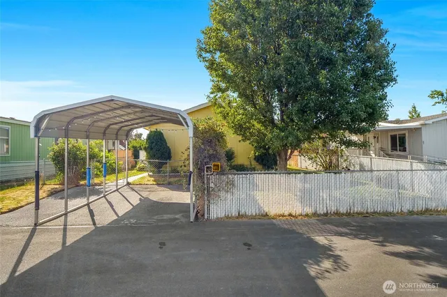 a view of patio with a table and chairs under an umbrella