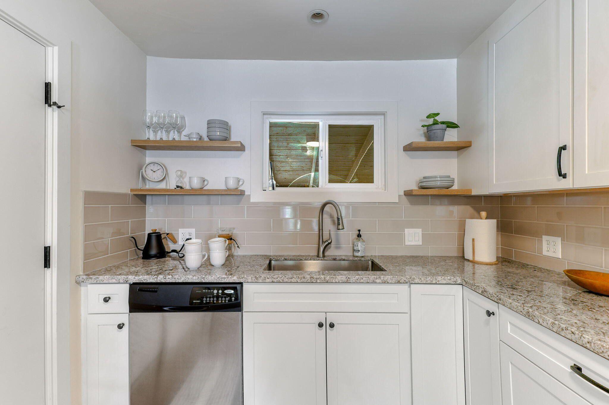 1005 Gold Street Redding, CA 96001 - Photo 11 of 26 a kitchen with granite countertop cabinets and wooden floor