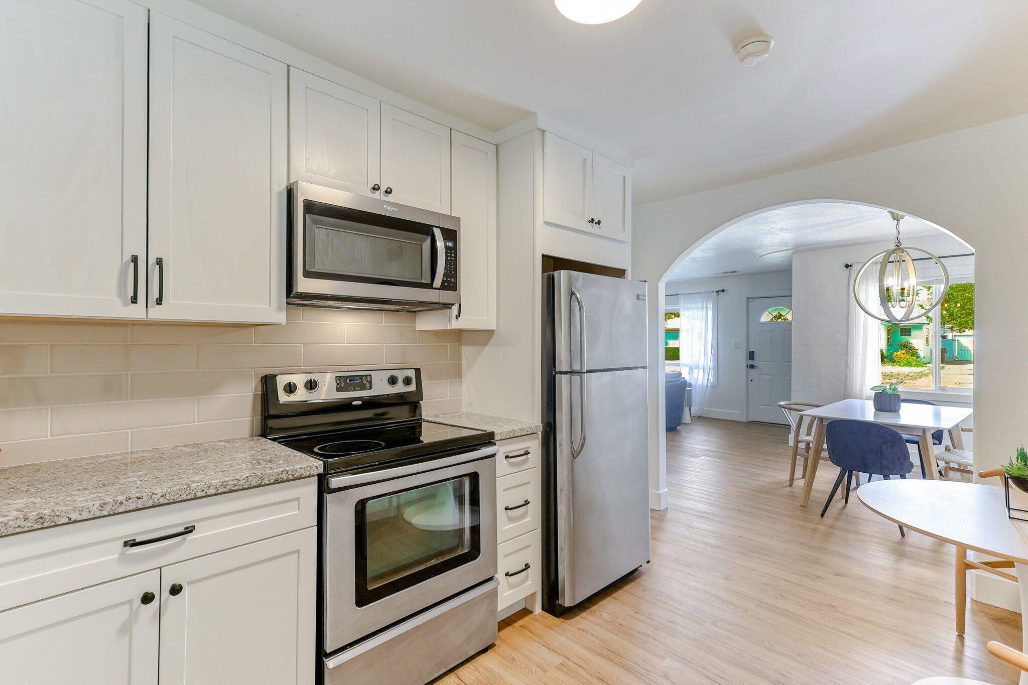 1005 Gold Street Redding, CA 96001 - Photo 12 of 26 a kitchen with stainless steel appliances a stove microwave and cabinets
