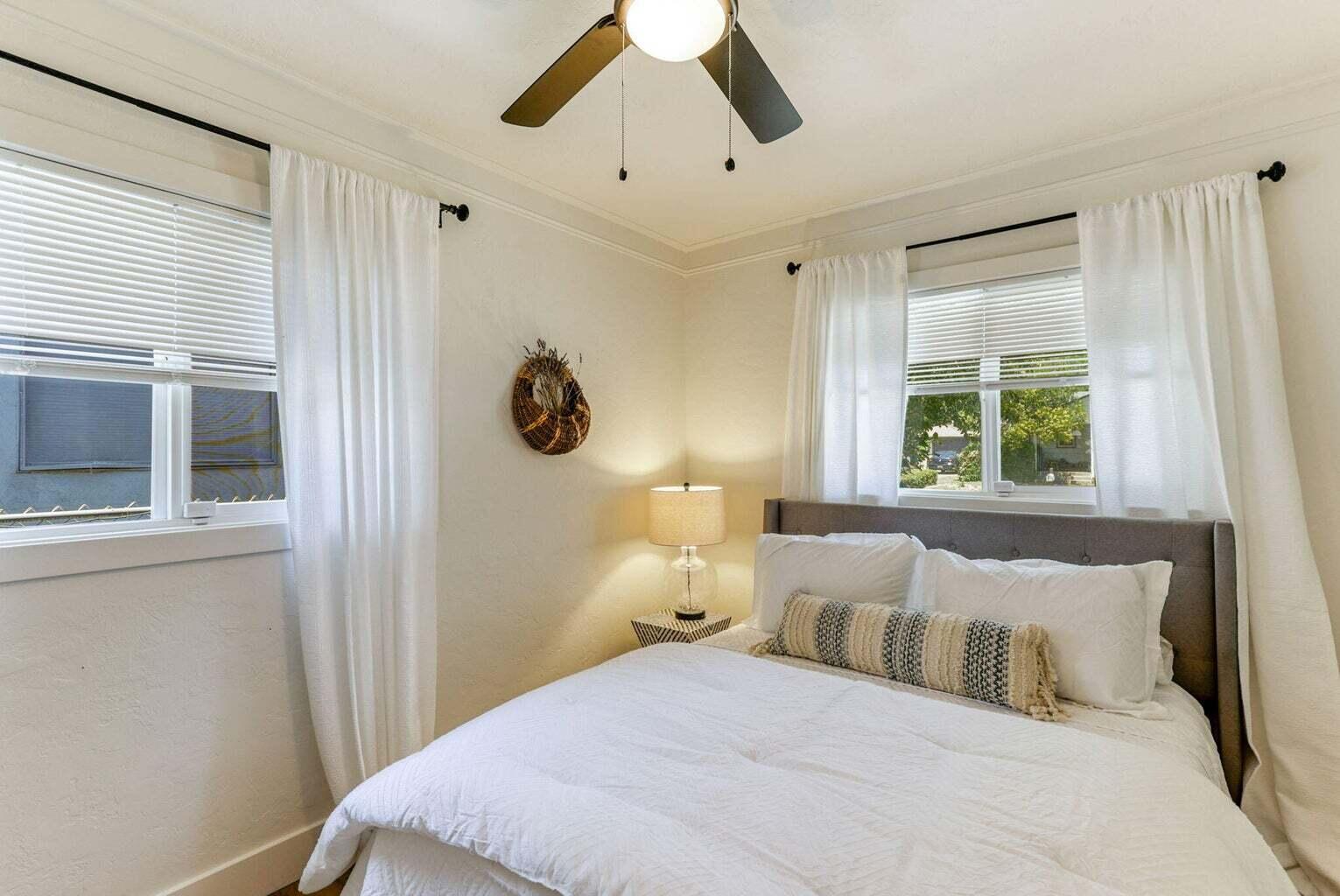 1005 Gold Street Redding, CA 96001 - Photo 15 of 26 a bedroom with a large bed and a window