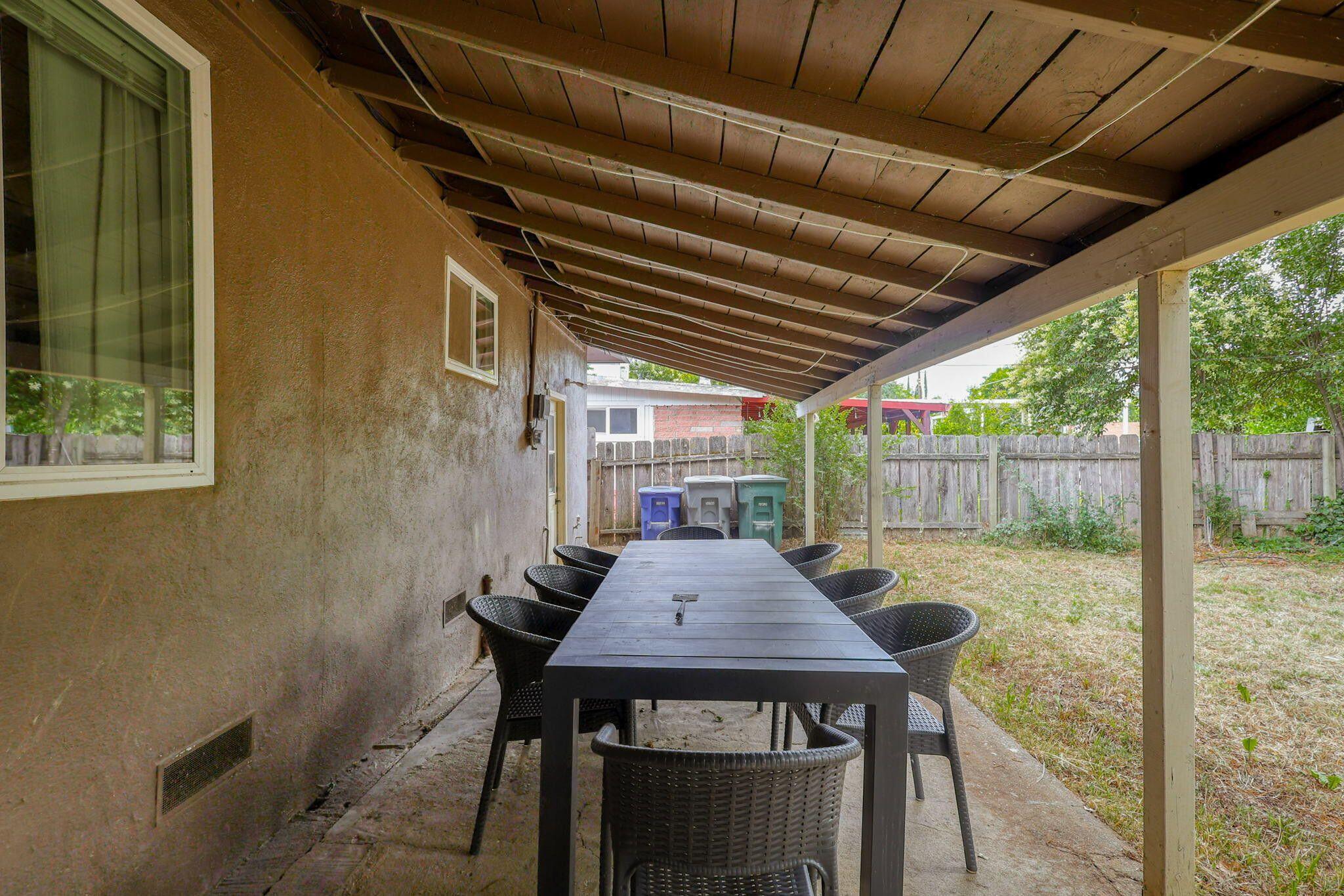 1005 Gold Street Redding, CA 96001 - Photo 26 of 26 a view of a patio with table and chairs under an umbrella with a small yard