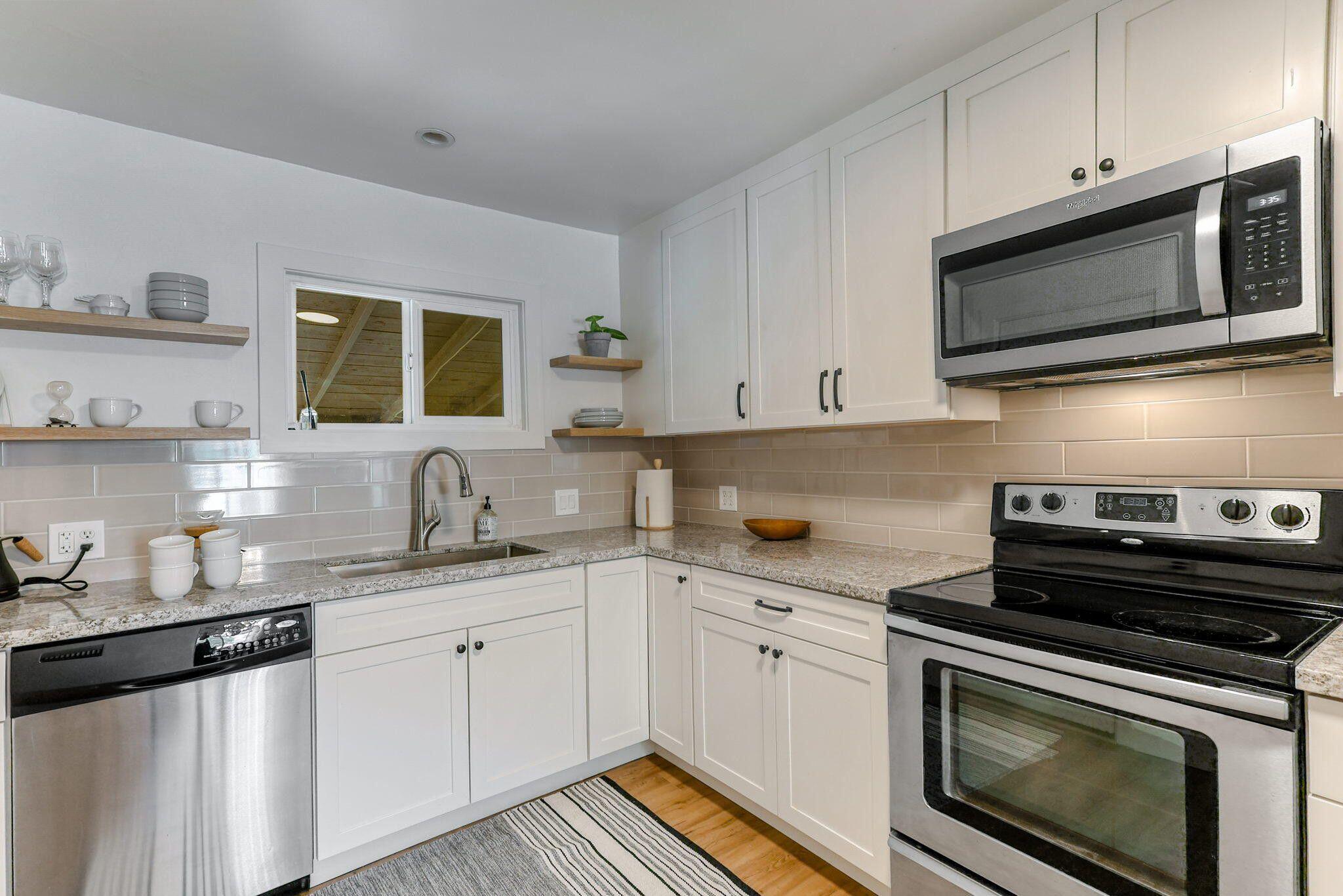1005 Gold Street Redding, CA 96001 - Photo 10 of 26 a kitchen with stainless steel appliances granite countertop a sink a stove a microwave and cabinets