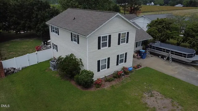 a aerial view of a house next to a yard