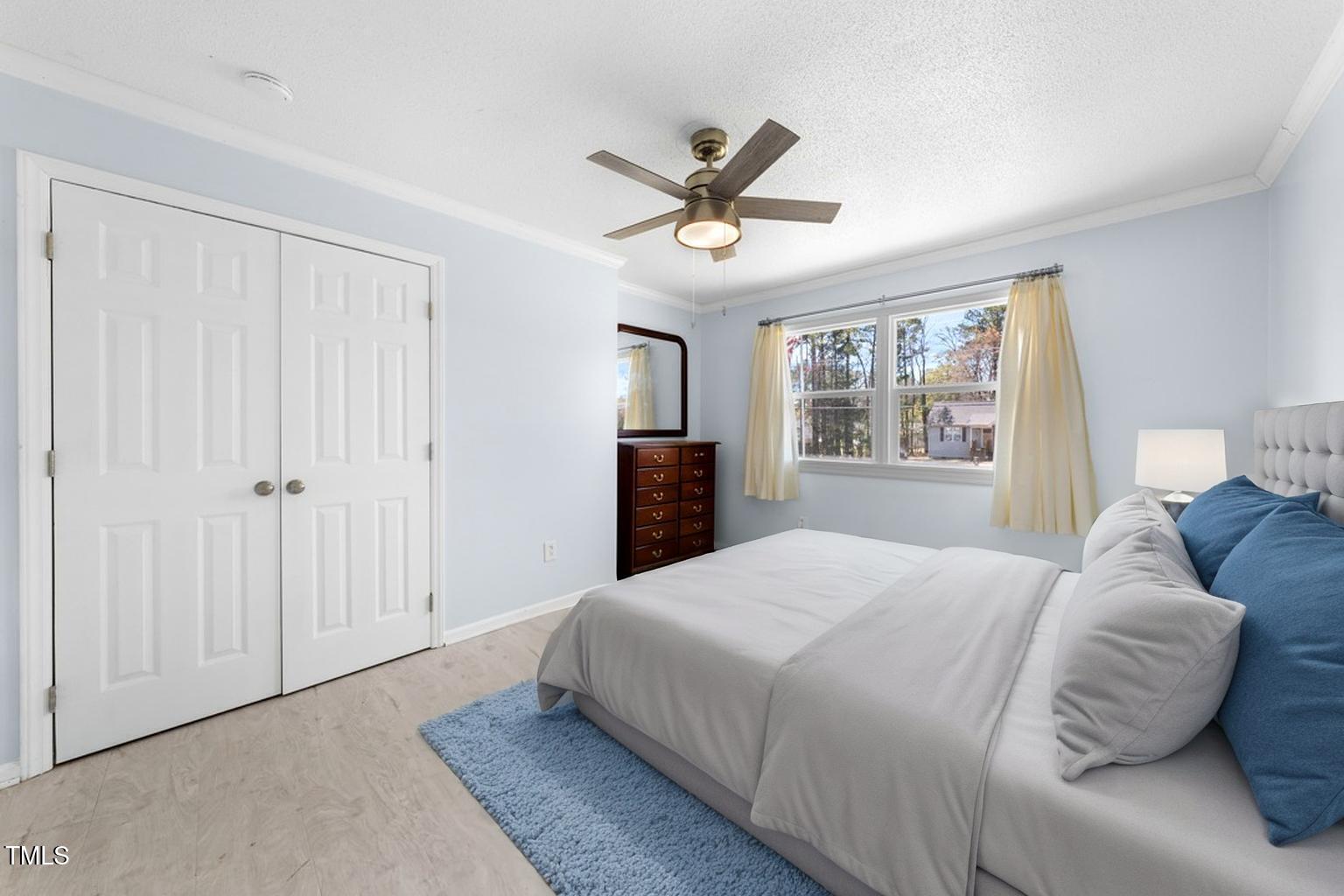 916 Clayton Road Durham, NC 27703 - Photo 8 of 32 a bedroom with a large bed and a window