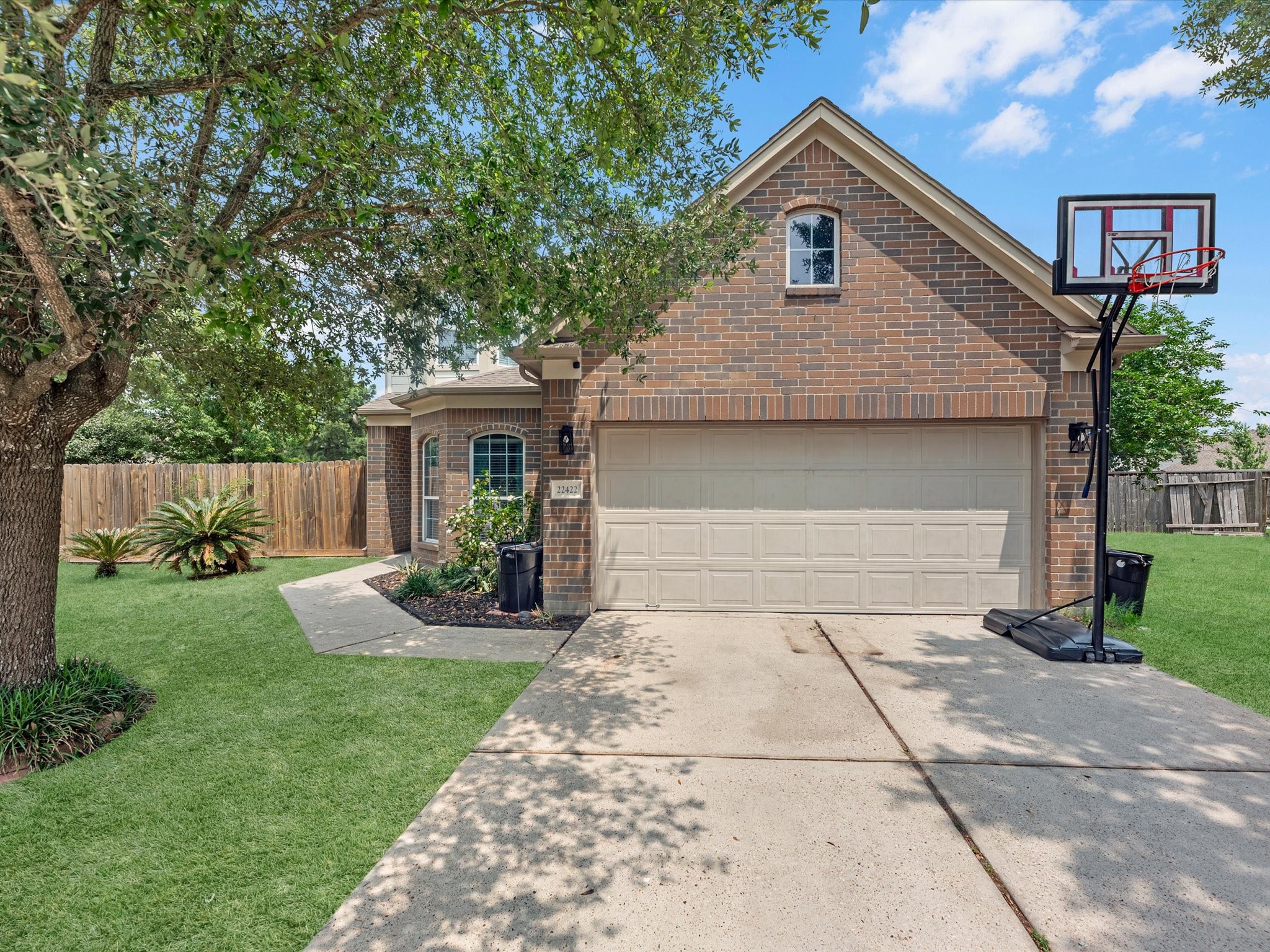 22422 Lamaster Lane Spring, TX 77373 - Photo 1 of 35 This charming brick home features a two-car garage, a well-maintained front yard with mature trees and a curved pathway leading to the entrance, offering a welcoming curb appeal.