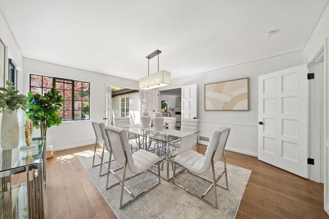 a kitchen with stainless steel appliances a sink and a wooden floors