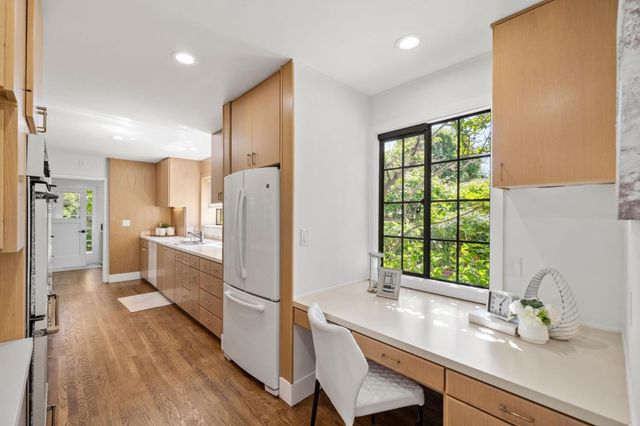 a view of a kitchen with a sink and cabinets
