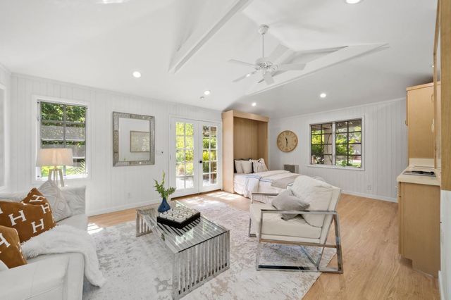 a view of staircase with wooden floor and white walls
